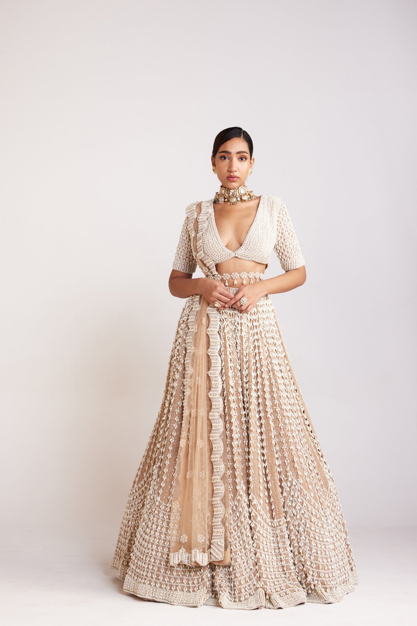 V Vani Vats Beige Chandelier Pearl Lehenga Paired With Heavily Pearl Embellished V Neck Blouse With Elbow Sleeve Indian designer wear online shopping melange singapore