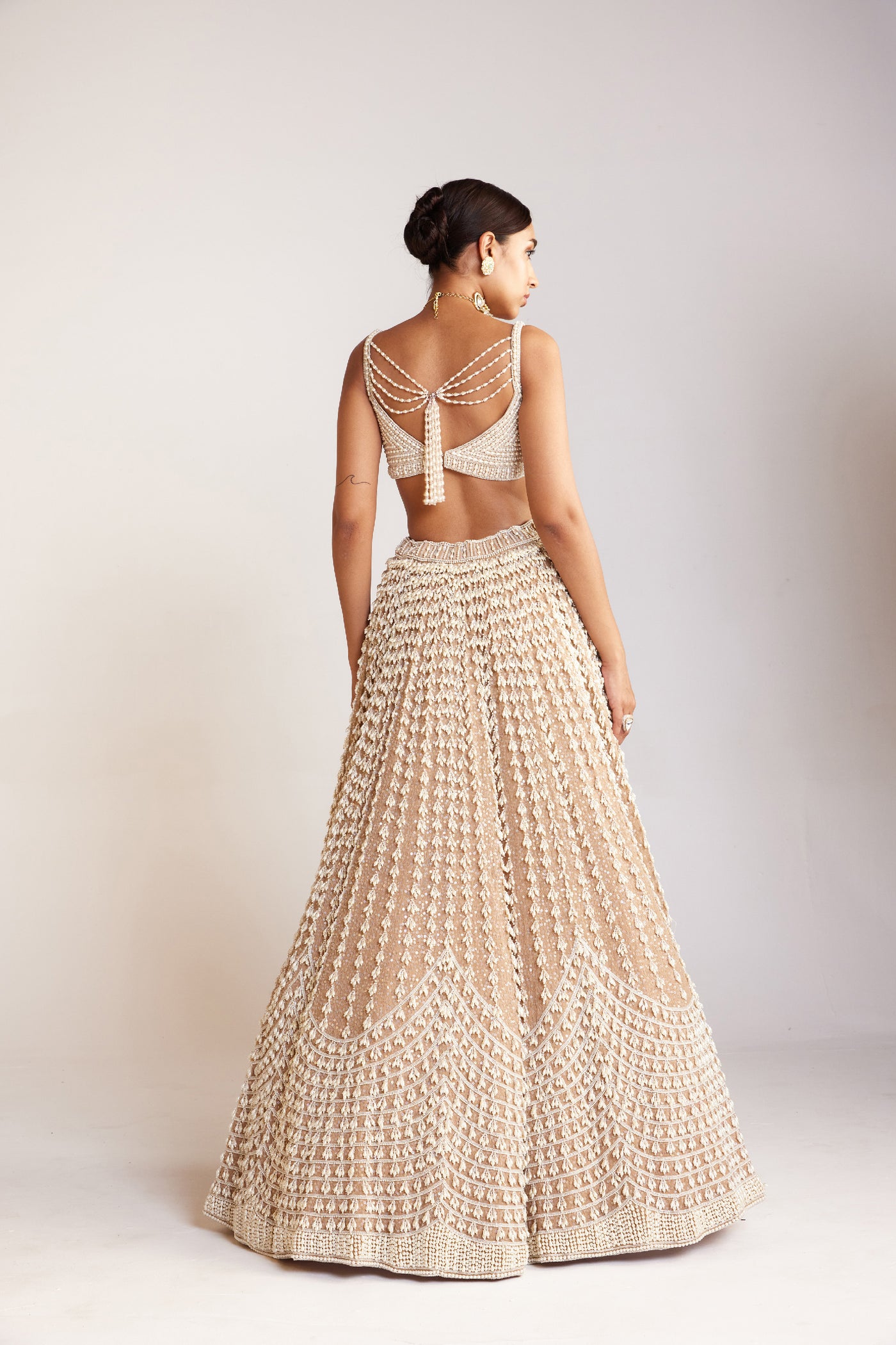 V Vani Vats Beige Chandelier Pearl Lehenga Paired With Sleeveless Pearl Drop Sweetheart Neck Blouse Indian designer wear online shopping melange singapore