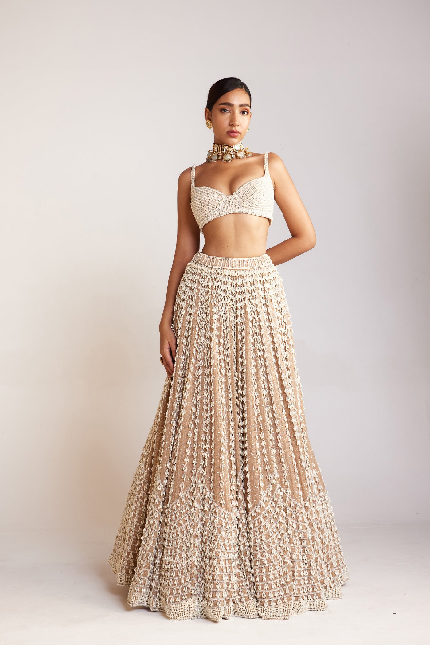 V Vani Vats Beige Chandelier Pearl Lehenga Paired With Sleeveless Pearl Drop Sweetheart Neck Blouse Indian designer wear online shopping melange singapore