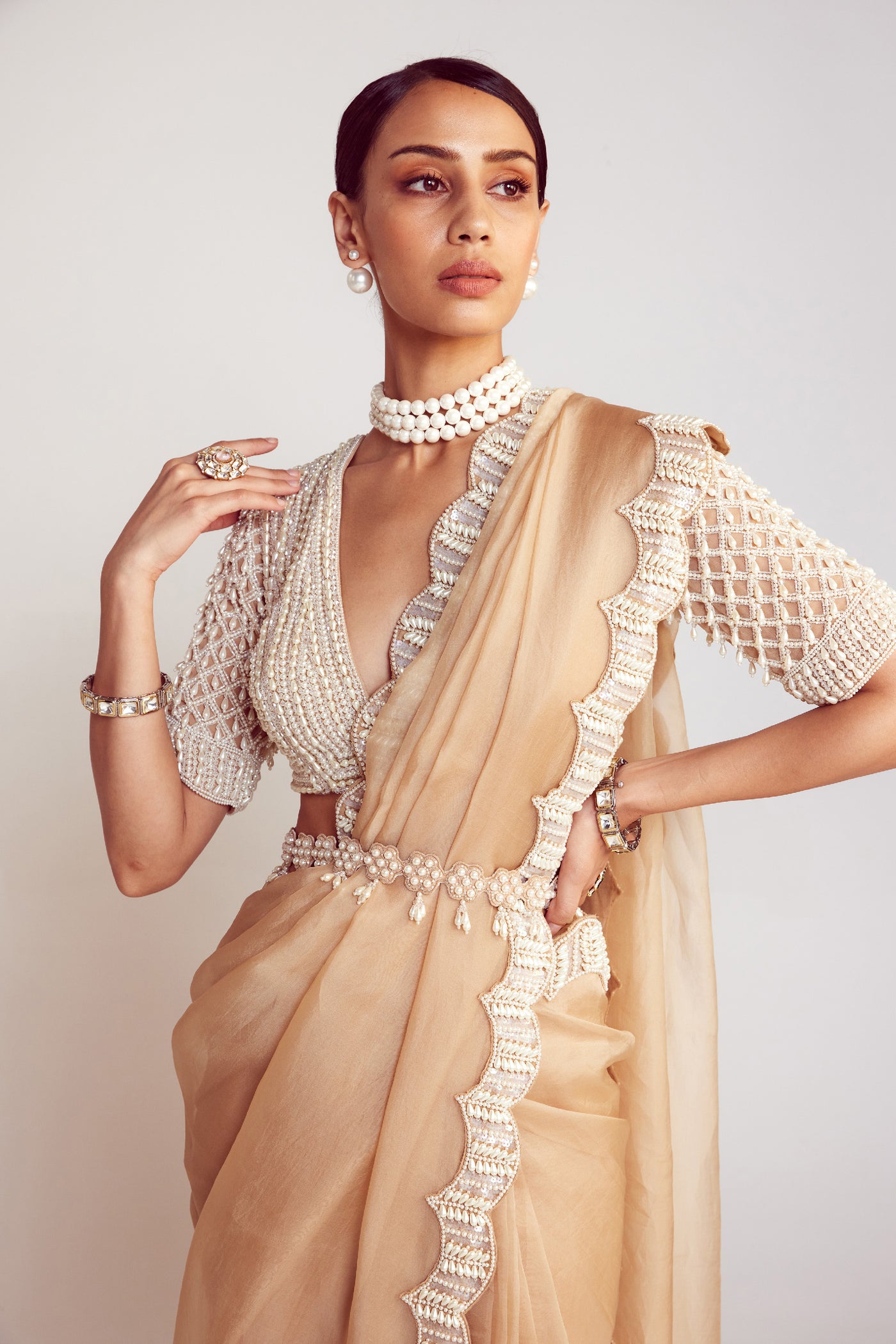 V Vani Vats Beige Pearl Embellished Organza Saree Paired With V Neck Elbow Sleeve Pearl Drop Blouse Indian designer wear online shopping melange singapore