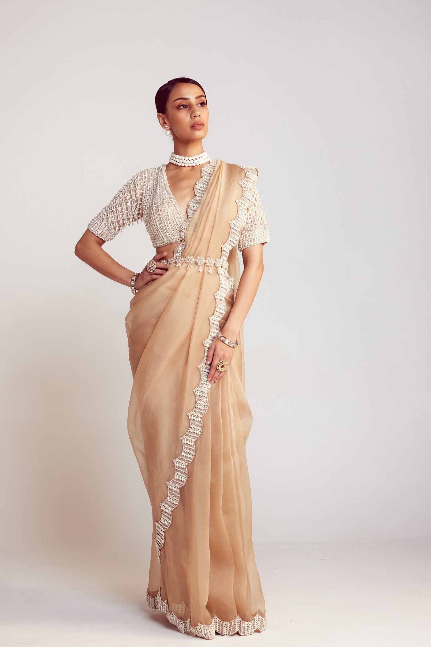 V Vani Vats Beige Pearl Embellished Organza Saree Paired With V Neck Elbow Sleeve Pearl Drop Blouse Indian designer wear online shopping melange singapore