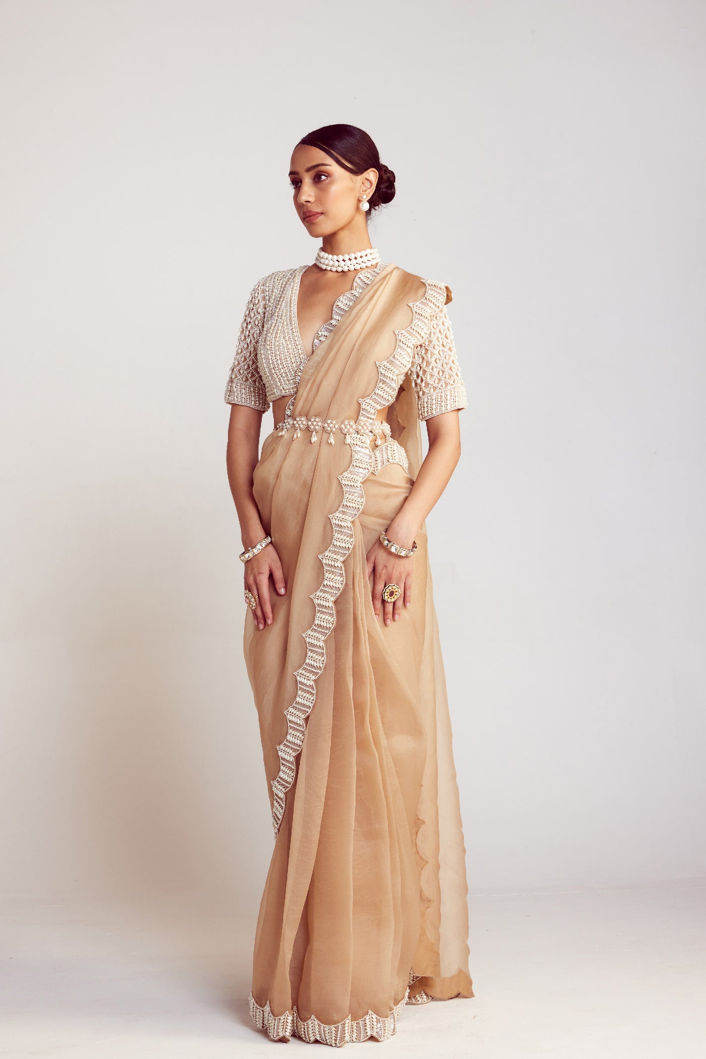 V Vani Vats Beige Pearl Embellished Organza Saree Paired With V Neck Elbow Sleeve Pearl Drop Blouse Indian designer wear online shopping melange singapore