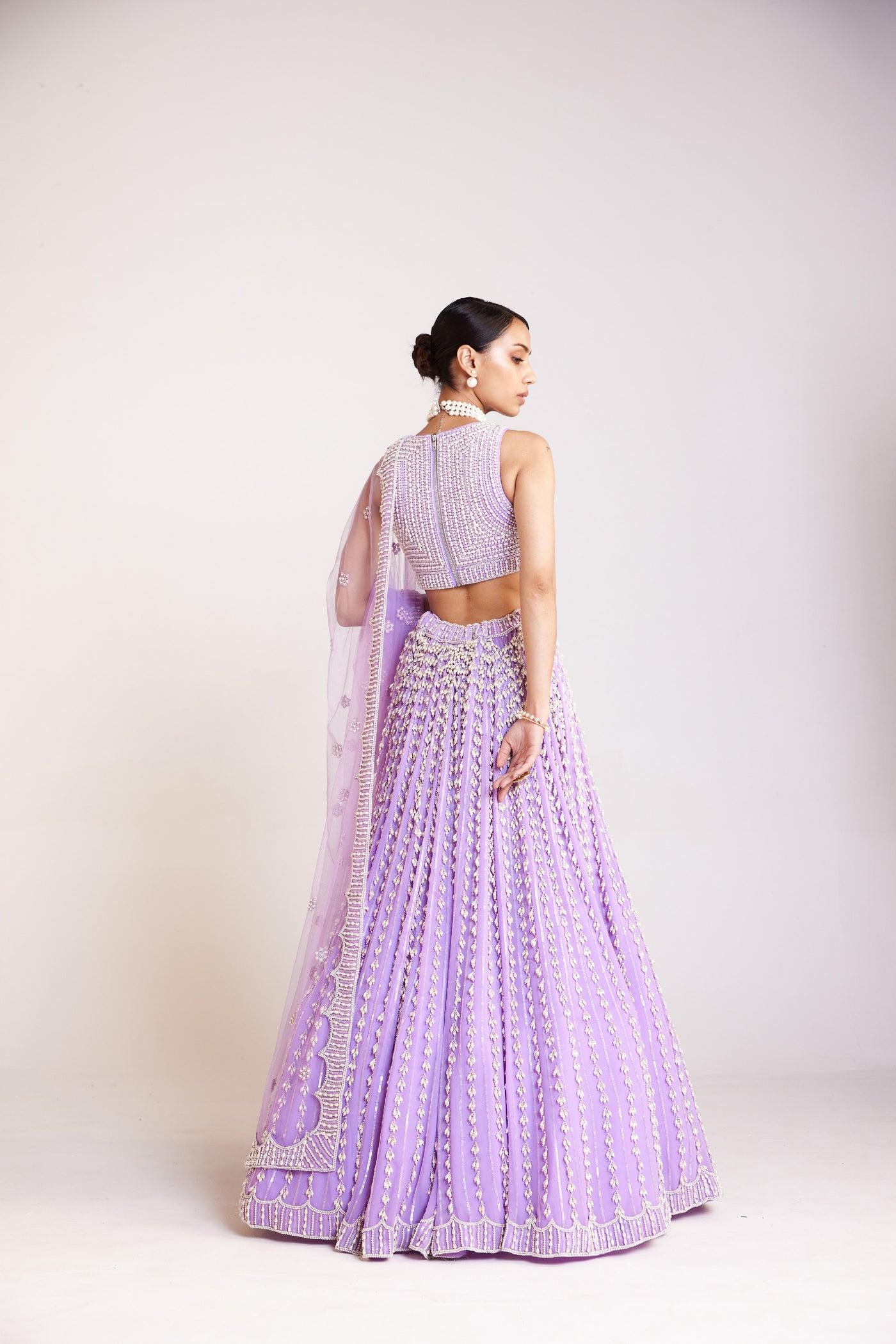 V Vani Vats Lilac Chandelier Pearl Lehenga Paired With V Neck Heavily Embellished Pearl Blouse Indian designer wear online shopping melange singapore