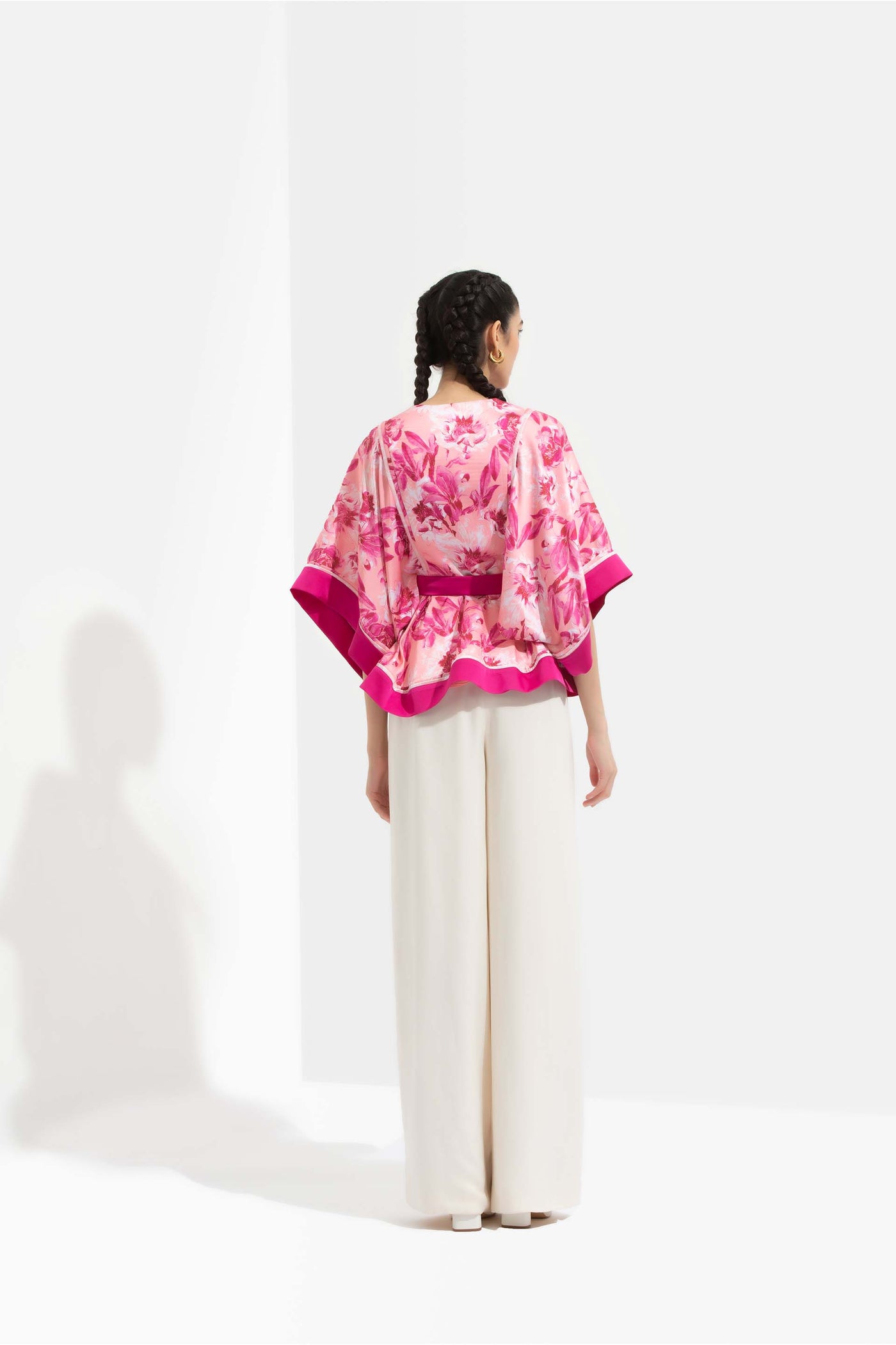 Mandira Wirk Sakura printed satin peplum top with kimono sleeves and deep pink color blocked facing, paired with ivory pants pink western indian designer wear online shopping melange singapore