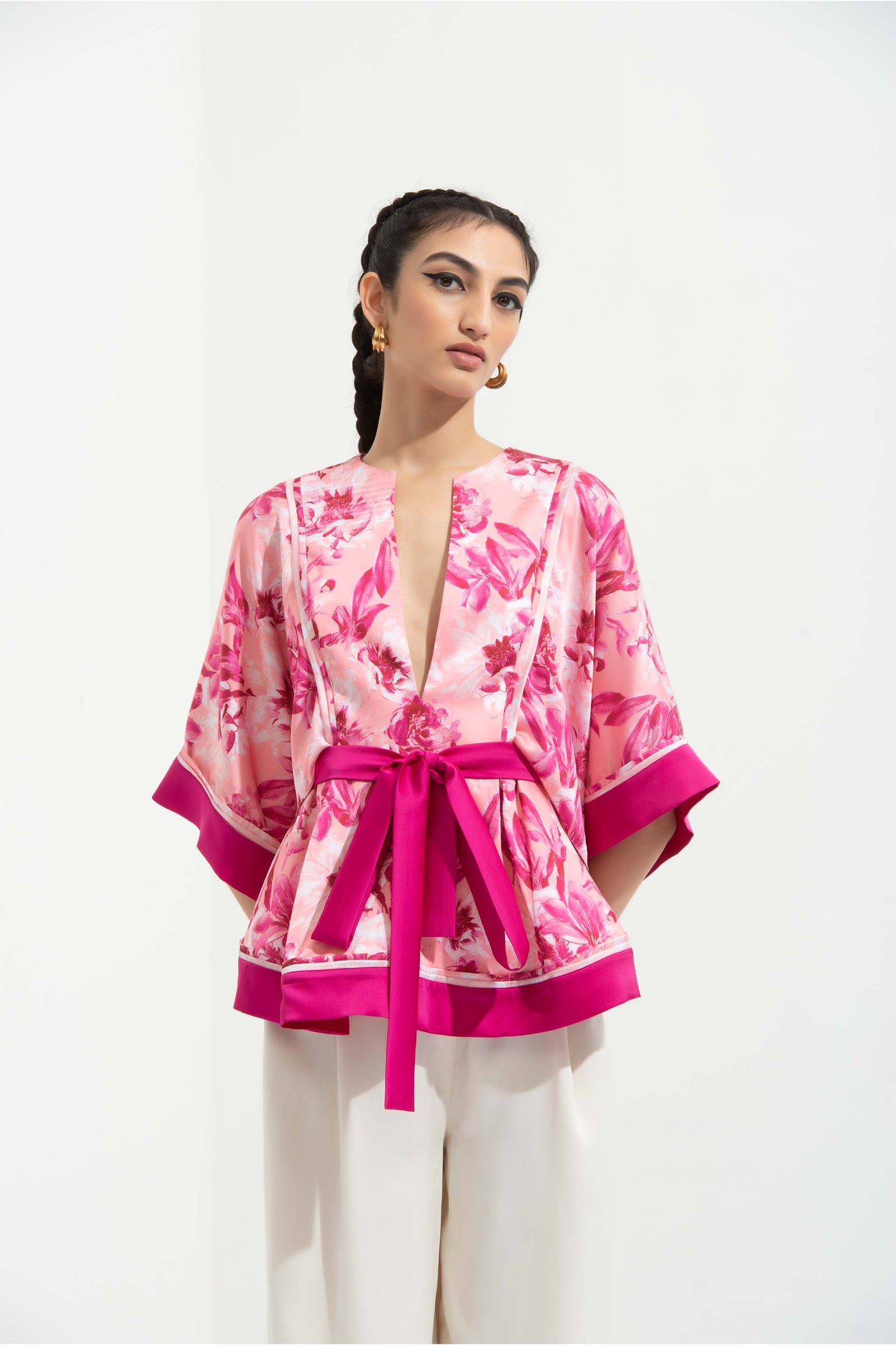 Mandira Wirk Sakura printed satin peplum top with kimono sleeves and deep pink color blocked facing, paired with ivory pants pink western indian designer wear online shopping melange singapore